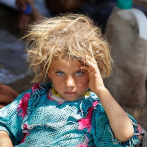 Yazidi girl rests after fleeing ISIS